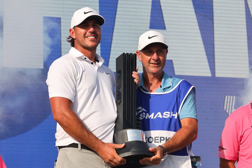 Brooks Koepka and caddie Ricky Elliot celebrate after the American's win at LIV Golf Jeddah.