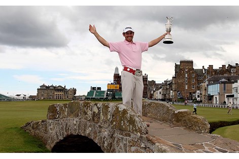 Louis Oosthuizen poses with the Claret Jug on the Swilcan Bridge after winning the 2010 Open at St Andrews.
