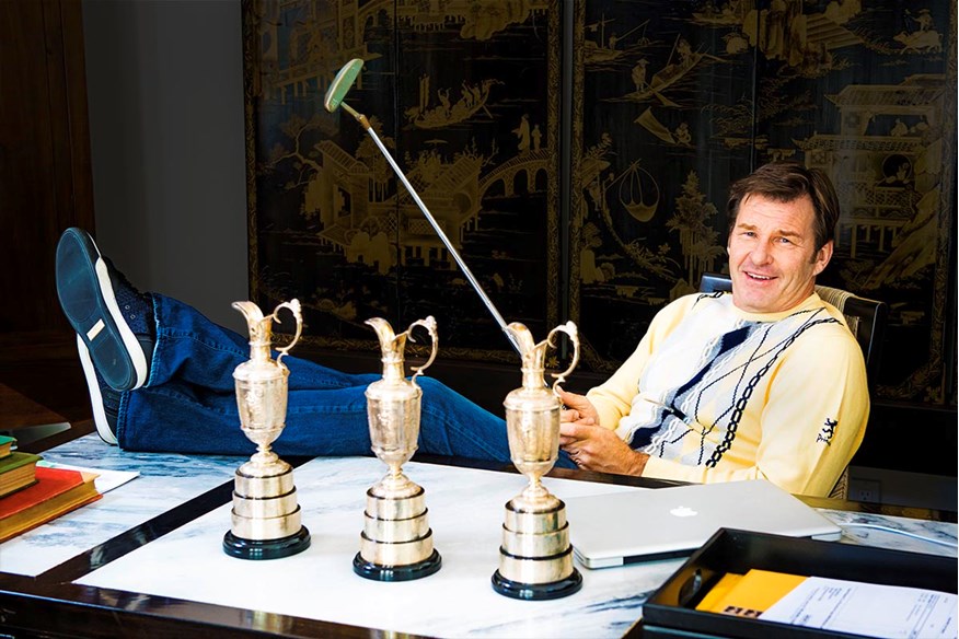 Sir Nick Faldo poses with his three replica Claret Jugs.