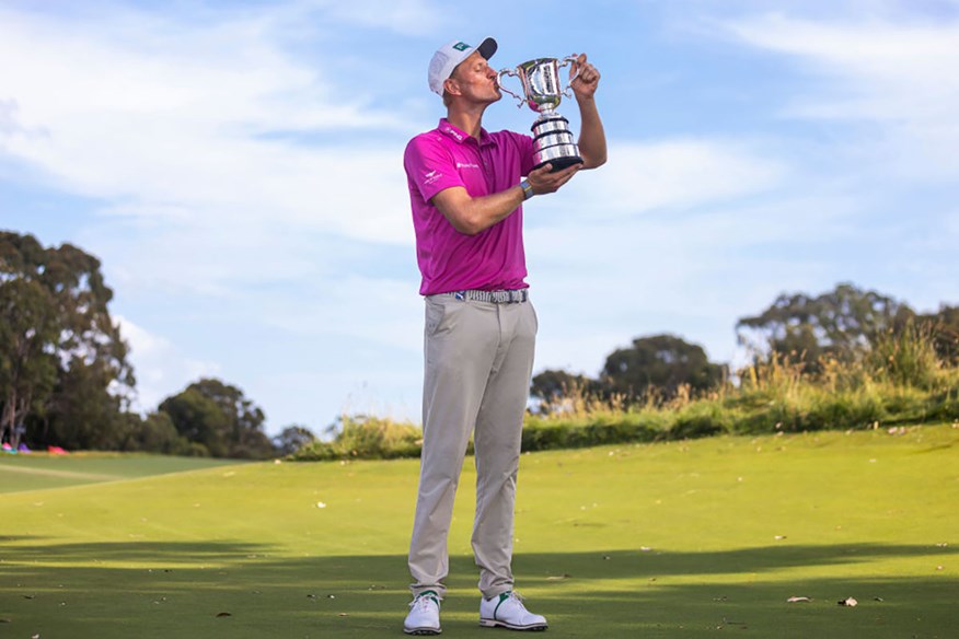 Adrian Meronk holding the 2022 Australian Open Trophy in Melbourne.