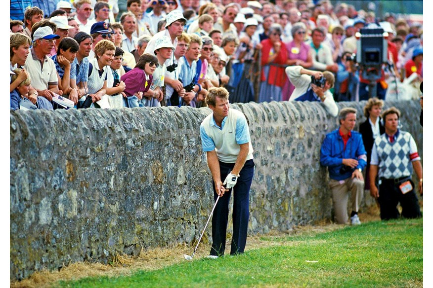 Tom Watson hits a shot from against the wall at St Andrews