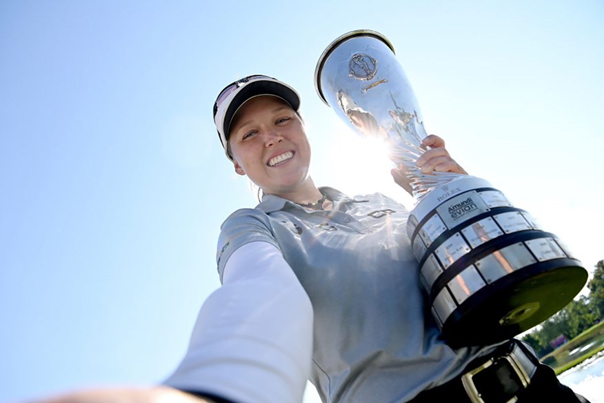 Brooke Henderson poses with the trophy after winning her second Major at the Evian Championship.