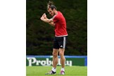 Gareth Bale checks his golf technique during Wales training.