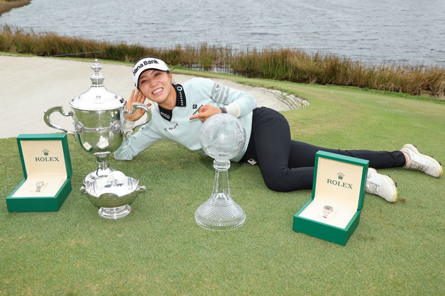 Lydia Ko with the tour championship and Vare trophy.