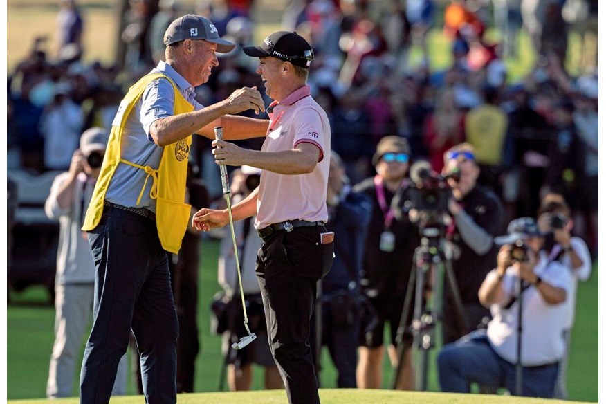 Justin Thomas and Bones celebrating victory.