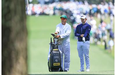 Patrick Cantlay consults with his caddie during the final round of the 2023 Masters.