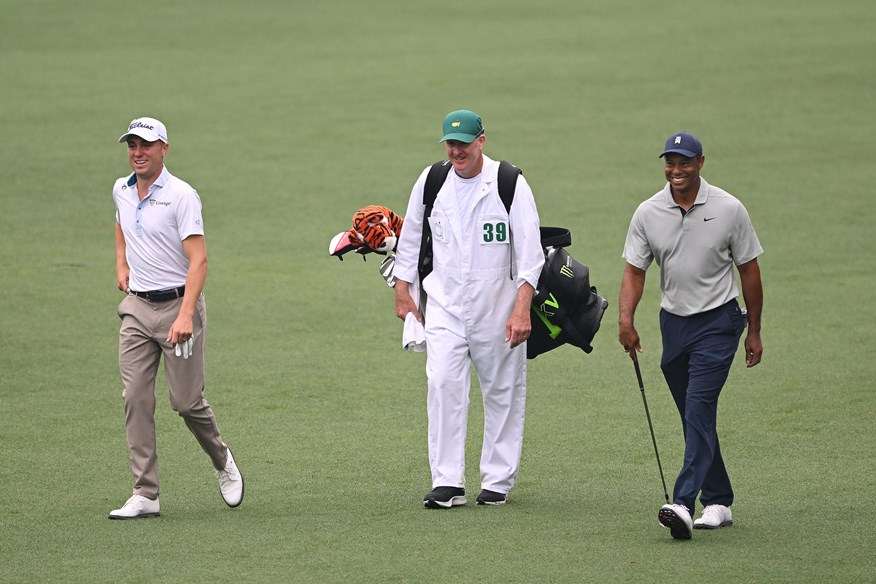 Justin Thomas, Joe LaCava and Tiger Woods share a laugh during a practice round at The Masters.