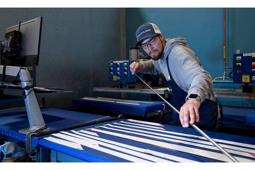 An image showing a Fujikura technician rolling graphite shafts