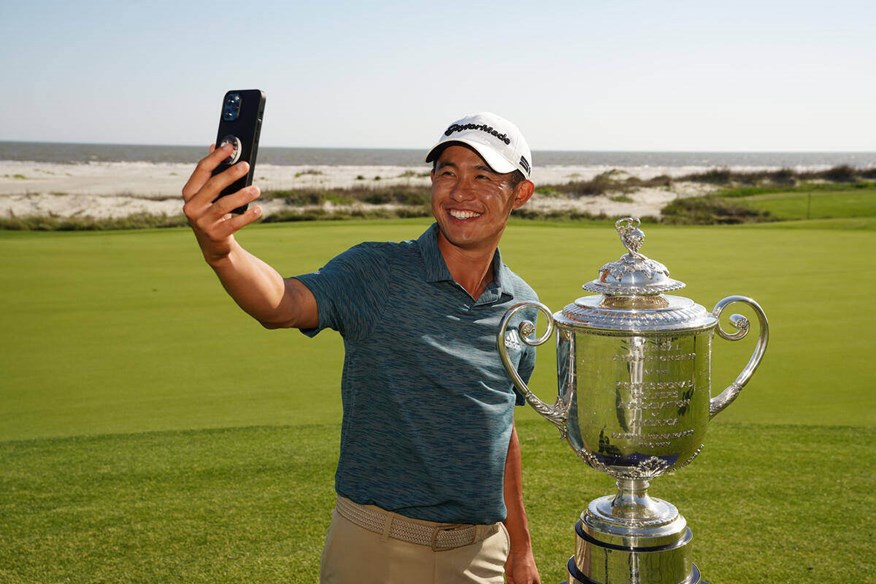 Collin Morikawa taking a selfie alongside the Wanamaker Trophy.