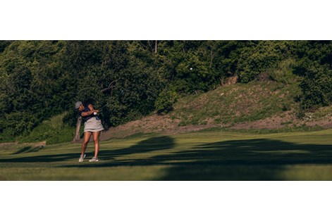 A golfer hitting the Titleist T150 2023 iron