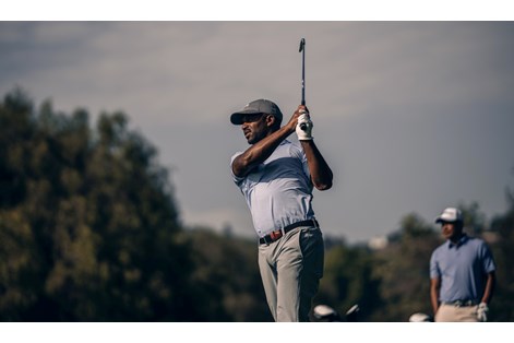 A golfer hitting the Titleist T200 2023 iron