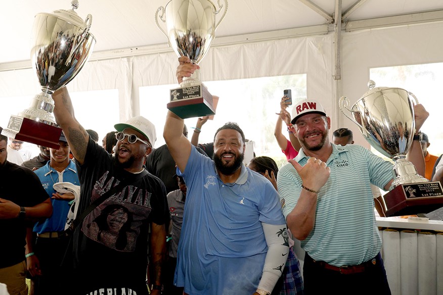 DJ Khaled celebrating a celebrity pro-am victory with Michael Block.