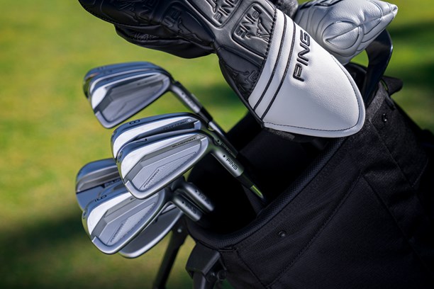 A set of Ping Blueprint S Irons sat in a golf bag