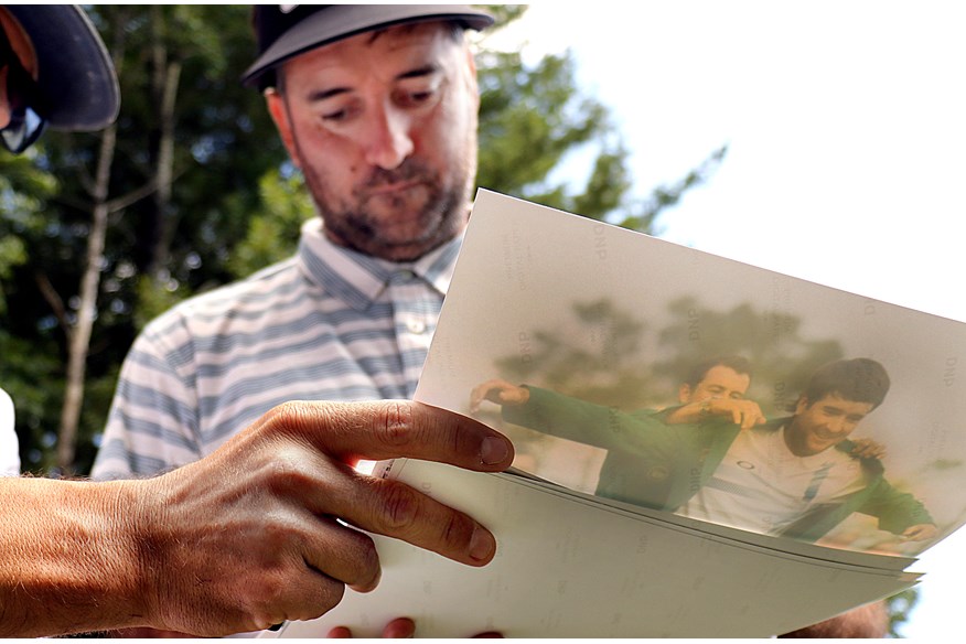 Bubba Watson signing a picture of his 'greatest moment' at Augusta National.