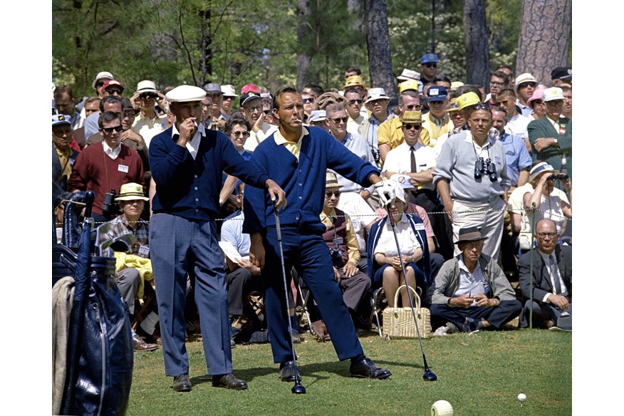 Ben Hogan and Arnold Palmer smoke as they wait to play their tee shot on the second hole during the 1966 Masters.