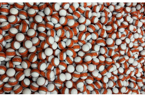 Hundreds of TaylorMade Tour Response Stripe golf balls inside the Liberty golf ball plant