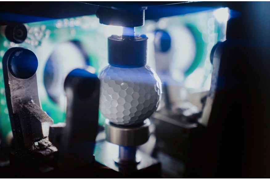 An AI driven machine aligning a TaylorMade golf ball for printing