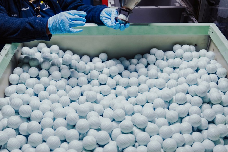 Hundreds of unfinished TaylorMade golf balls waiting to be painted