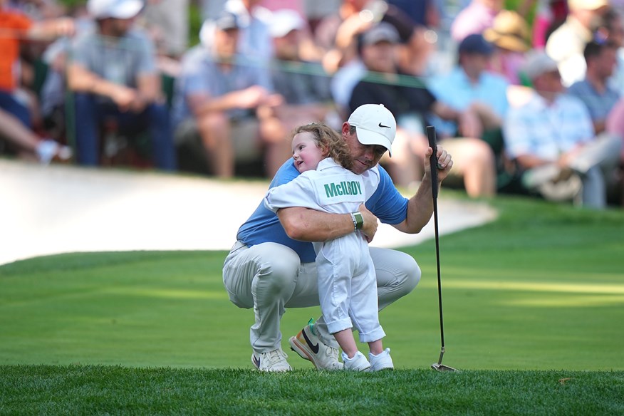 Rory McIlroy embraces daughter Poppy during the 2023 Masters Par 3 Contest but won't be teeing it up in 2024.