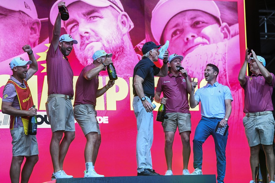 Greg Norman downs a beer from a shoe on stage at LIV Golf Adelaide.