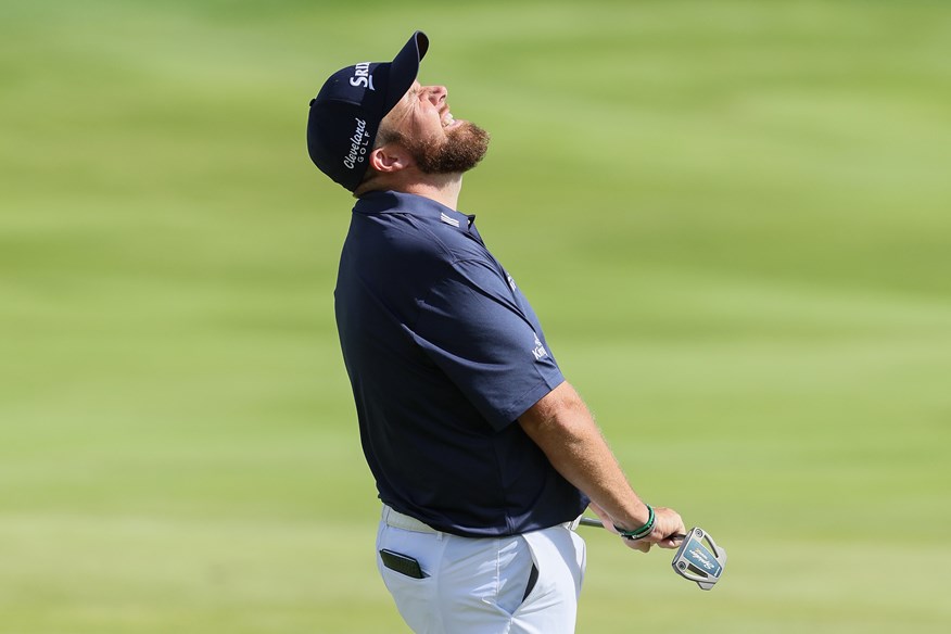 Shane Lowry grimaces as his putt for a 61 slips by.