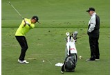 Butch Harmon keeps an eye on Rickie Fowler on the range.