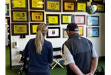 Iona Stephen and Butch Harmon cast an eye over the flags of all the victories he's coached players to.