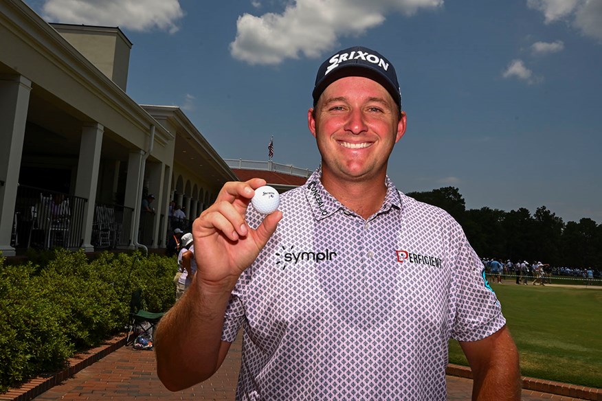 Sepp Straka smiles with his golf ball after making a hole-in-one at the 2024 US Open