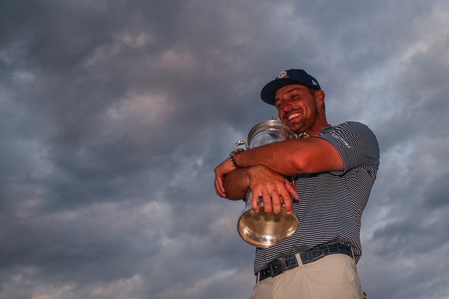 Bryson DeChambeau hugging the US Open trophy