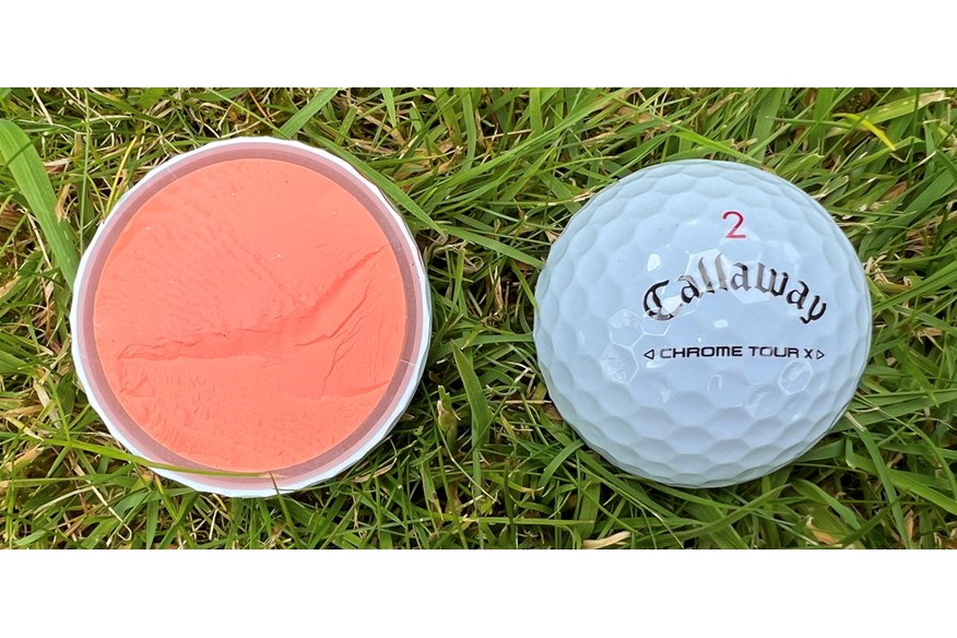 A Callaway Chrome Tour X golf ball cut in half to show the layers inside