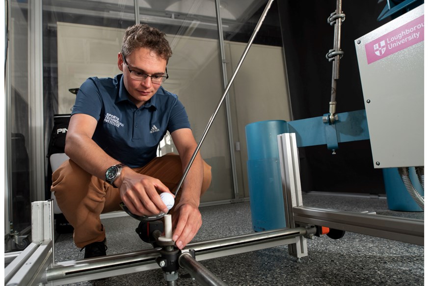 PhD Researcher James Morris setting up up the robot to swing driver