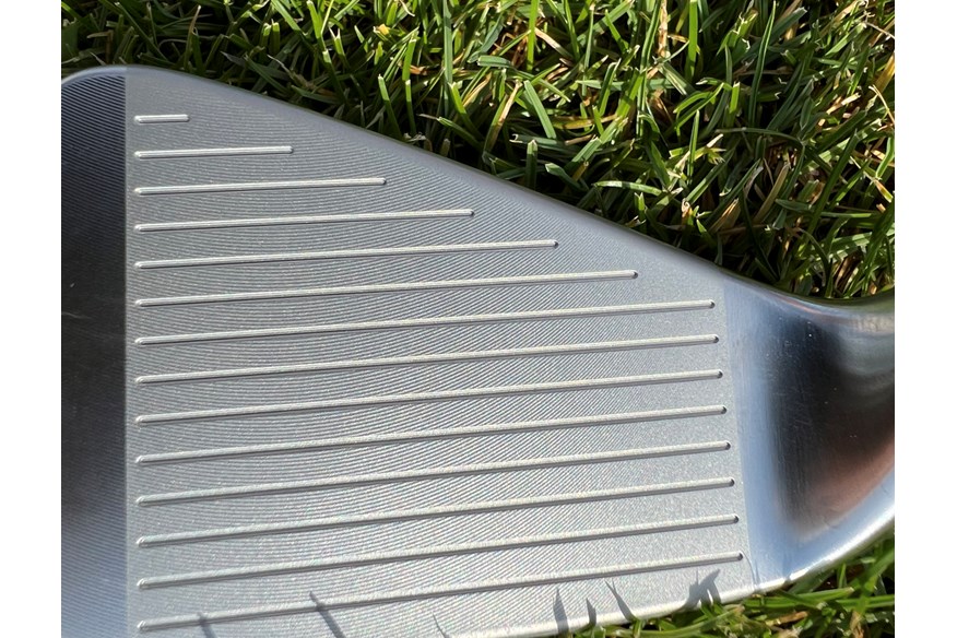 A close up of the CNC milled face and grooves on the TaylorMade P7CB iron.