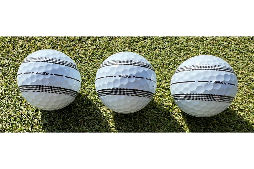 A close up of the TaylorMade TP5x Stripe golf ball to show the alignment stripe and dimple pattern