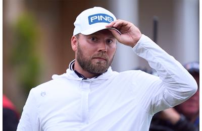 Dan Brown acknowledges the crowd after holing his birdie putt on the 18th hole at Royal Troon.