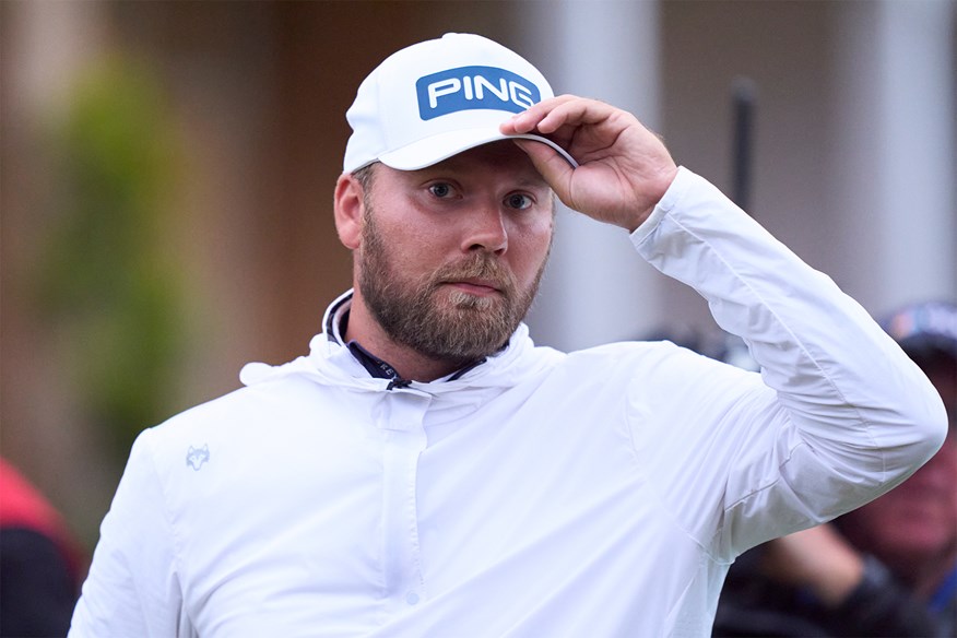 Dan Brown acknowledges the crowd after holing his birdie putt on the 18th hole at Royal Troon.