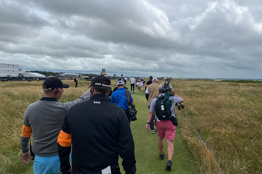 Walking down the hole with the players at The Open