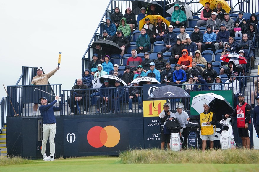 Calum Scott teeing off in the rain at Royal Troon on Saturday