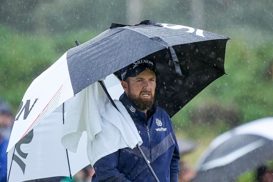 Lowry shelters from the elements at Royal Troon.