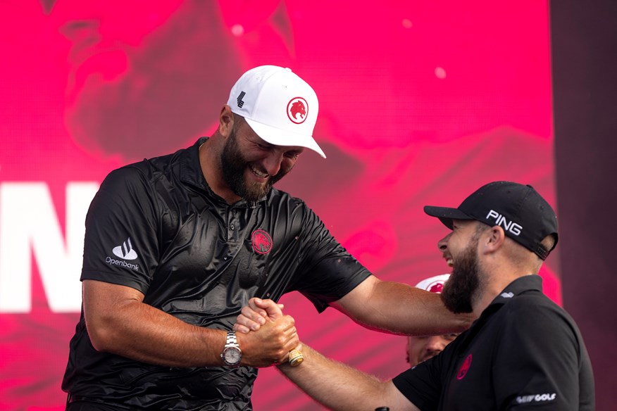 Jon Rahm being congratulated by teammate Tyrrell Hatton after winning in Chicago.