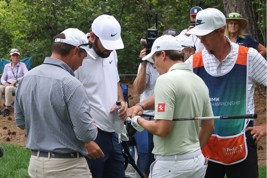 Matt Fitzpatrick points out his cracked driver face during the 2024 BMW Championship.