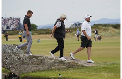 Dame Laura Davies and Shane Lowry walking over the Swilcan Bridge