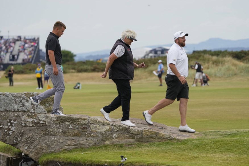 Dame Laura Davies and Shane Lowry walking over the Swilcan Bridge