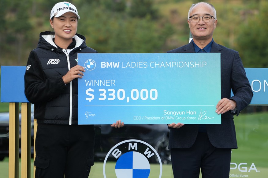 Minjee Lee picking up the winner's cheque at the 2023 BMW Ladies Championship