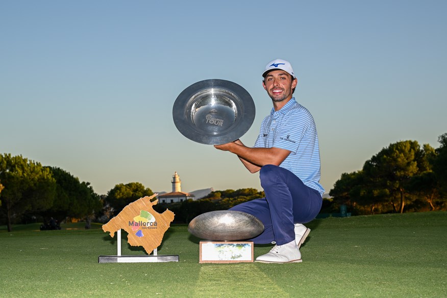 Marco Penge of England celebrates with the trophys following victory at the Rolex Challenge Tour Grand Final.