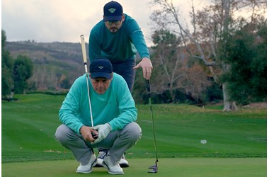 Sean Toulon and his Son, Preston, line up a putt with their new 2024 First Run Toulon Golf putter collection