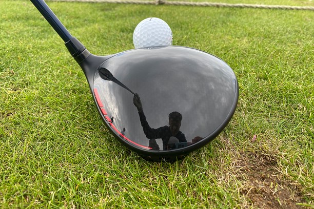 Wilson Dynapower Carbon driver head addressing the golf ball view from behind