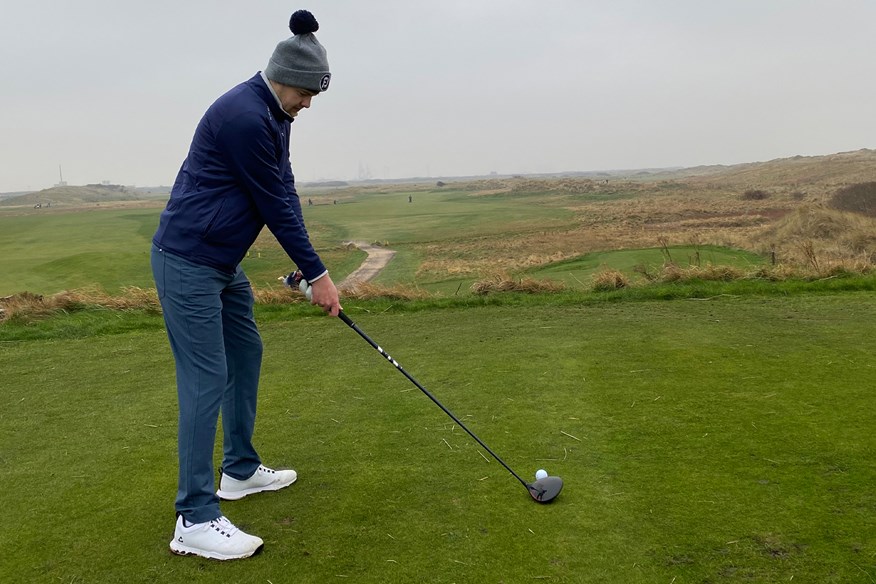 Setup over the golf ball ready to hit a shot with the Wilson Dynapower Carbon driver