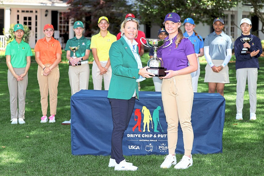 Presenting the trophy to the winner of the Drive, Chip and Putt Championship at Augusta National.