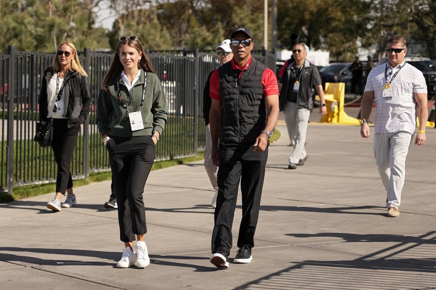 Tiger Woods walks with Kai Trump, while Vanessa Trump walks behind them.