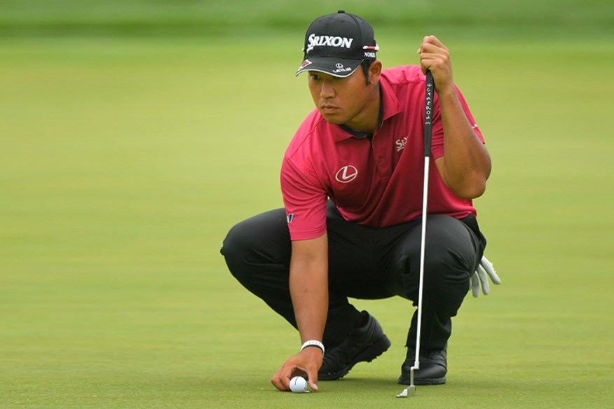 Hideki Matsuyama lines up a putt.